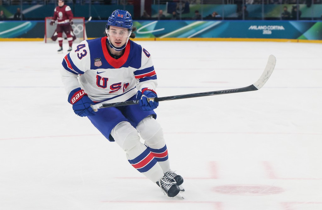 Quinn Hughes, who finally has a chance to play with his brother Jack, skates up ice during the United States' win over Latvia in Milan.