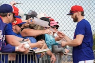 Texas Rangers outfielder Brandon Nimmo signs autographs during a spring training workout at...