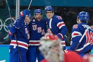 United States' Noah Hanifin, center, celebrates after scoring his side's fourth goal during...