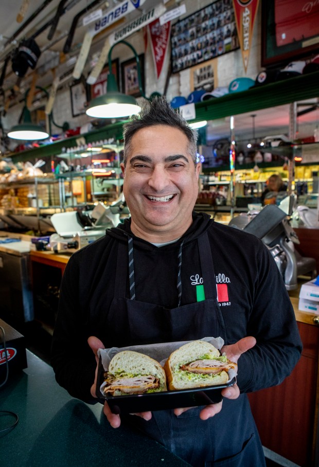 Chris Bertucelli shows off his Chris Combo sandwich, Tuesday, Feb. 21, 2023, at La Villa Delicatessen in San Jose, Calif. The sandwich, made from ingredients Bertucelli refuses to disclose, is a big hit with members of the Sharks and 49er organizations. (Karl Mondon/Bay Area News Group)