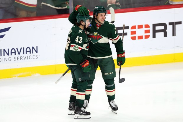 ST PAUL, MINNESOTA - DECEMBER 14: Quinn Hughes #43 of the Minnesota Wild celebrates his goal against the Boston Bruins with teammate Brock Faber #7 in the third period at Grand Casino Arena on December 14, 2025 in St Paul, Minnesota. The Wild defeated the Bruins 6-2. (Photo by David Berding/Getty Images)