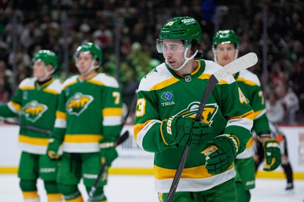 Minnesota Wild defenseman Quinn Hughes (43), front, waits for play to resume during the second period of an NHL hockey game against the Washington Capitals, Tuesday, Dec. 16, 2025, in St. Paul, Minn. (AP Photo/Abbie Parr)
