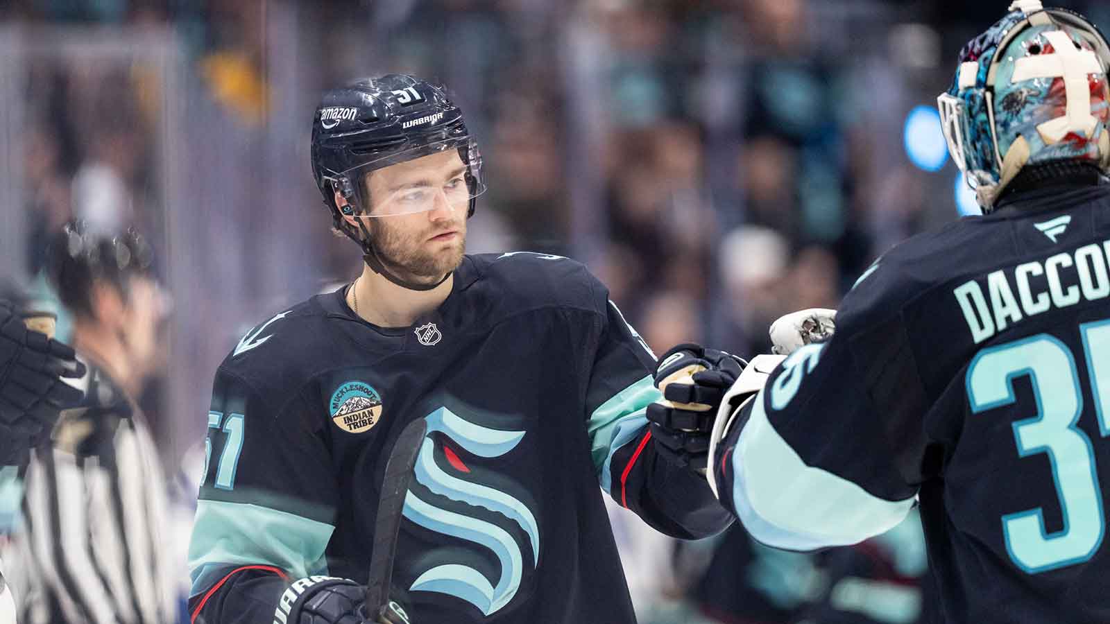 Seattle Kraken forward Shane Wright (51) celebrates a goal wiht Seattle Kraken goalie Joey Daccord (35) during the third period against the Toronto Maple Leafs at Climate Pledge Arena.