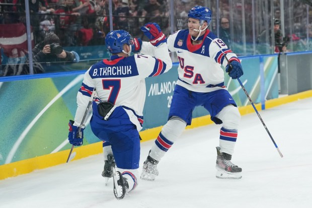United States' Brady Tkachuk, left, celebrates with teammate and brother Matthew Tkachuk after scoring a goal against Latvia at the 2026 Winter Olympics, in Milan, Italy, Thursday, Feb. 12, 2026. (AP Photo/Carolyn Kaster)