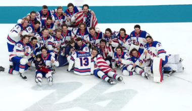 USA Hockey poses with the late Johnny Gaudreau's children, Noa and Johnny, along with his Team USA jersey, after winning the gold medal