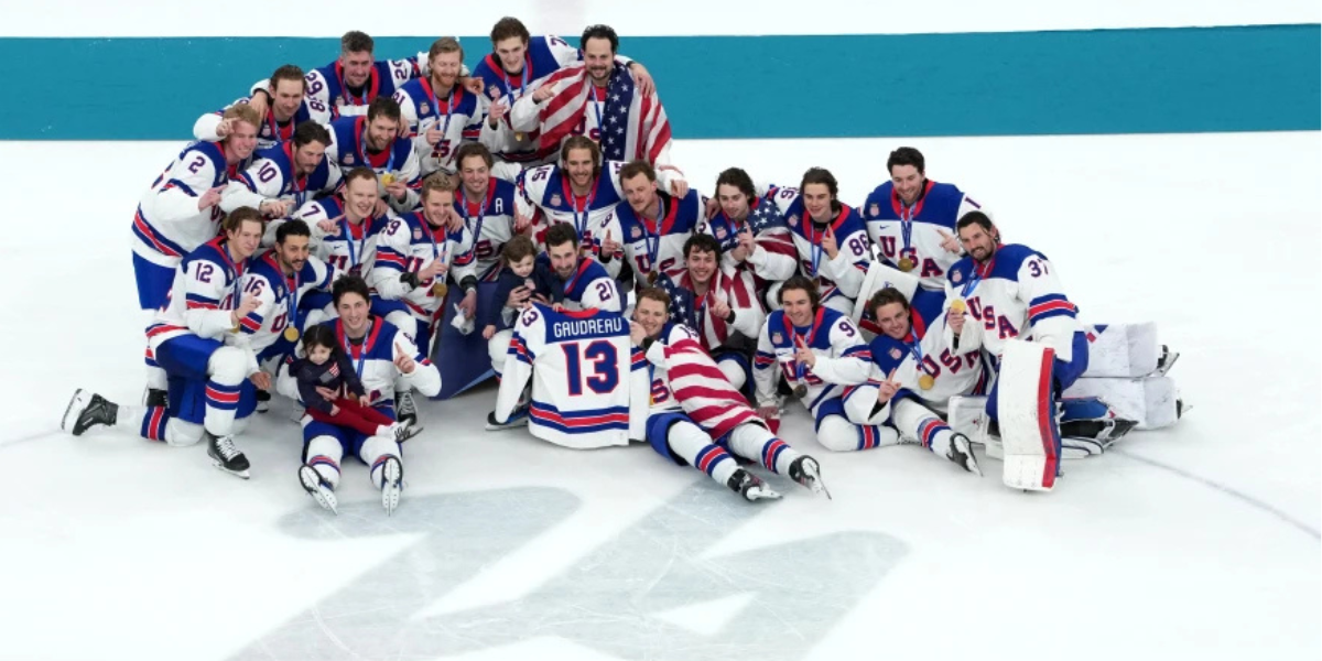 USA Hockey poses with the late Johnny Gaudreau's children, Noa and Johnny, along with his Team USA jersey, after winning the gold medal