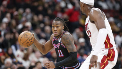 Jan 29, 2026; Chicago, Illinois, USA; Chicago Bulls guard Ayo Dosunmu (11) drives to the basket against Miami Heat center Bam Adebayo (13) during the first half at United Center.