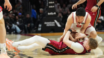 Jan 31, 2026; Miami, Florida, USA; Chicago Bulls guard Yuki Kawamura (8) battles for a loose ball with Miami Heat guard Kasparas Jakucionis (25) during the second half at Kaseya Center.