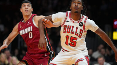 Jan 31, 2026; Miami, Florida, USA; Chicago Bulls forward Julian Phillips (15) battles for a rebound with Miami Heat forward Simone Fontecchio (0) during the second half at Kaseya Center.