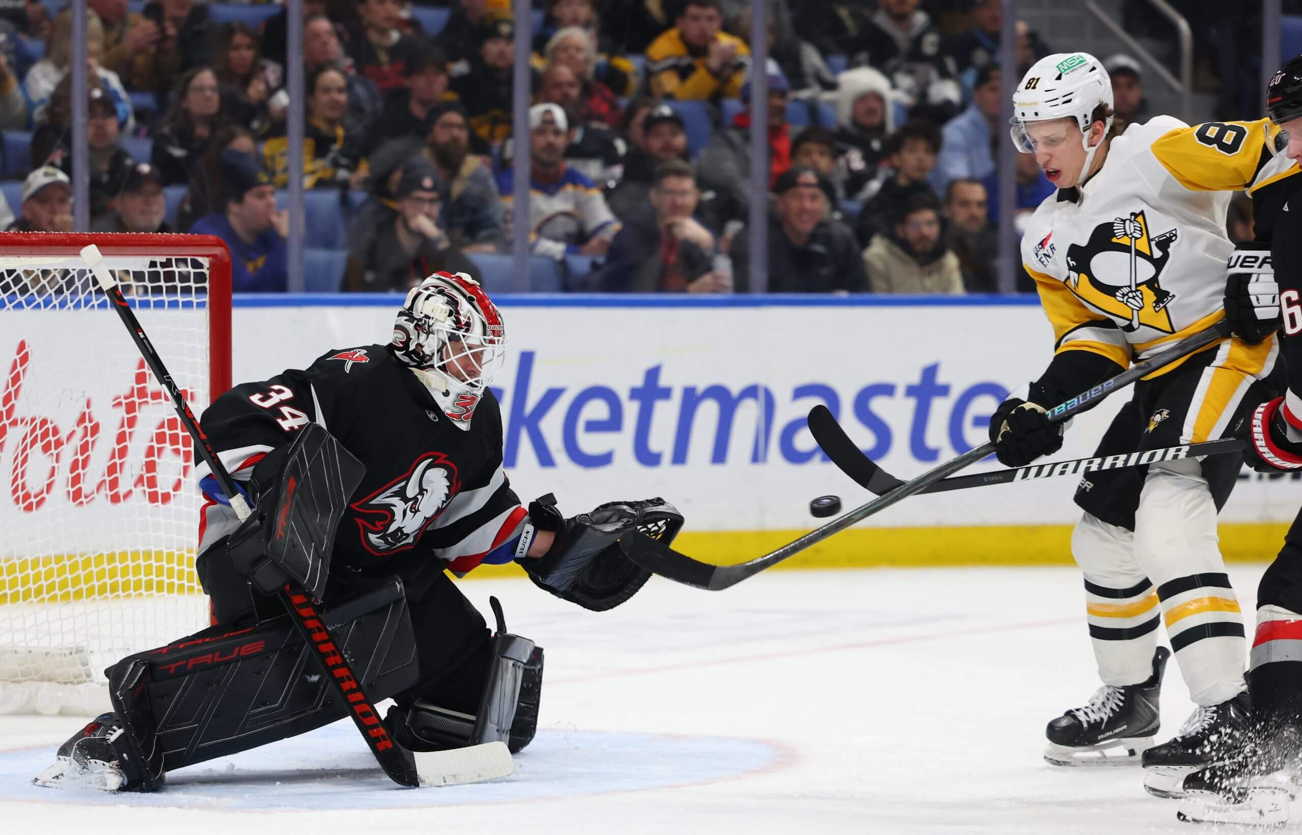 Alex Lyon makes a save against Penguins forward Ben Kindel.