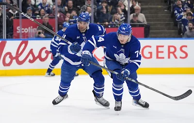 Toronto Maple Leafs forward Bobby McMann skates for the puck during 2026 game.
