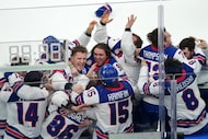 United States players celebrate after defeating Canada 2-1 in overtime to win the men's ice...