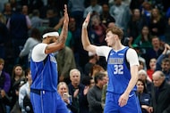 Dallas Mavericks forward Cooper Flagg (32) high-fives forward Anthony Davis (3) after...