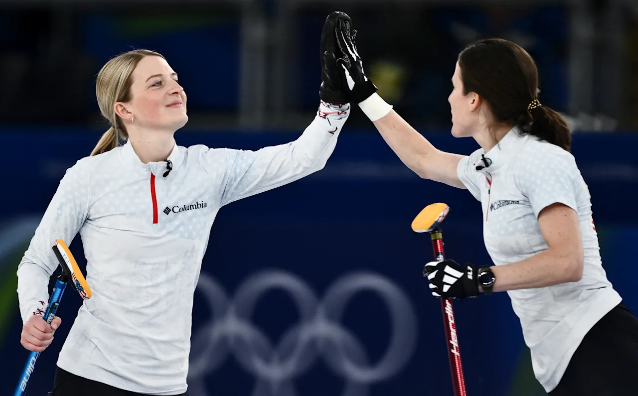 USA's Cory Thiesse (L) and USA's Tara Peterson celebrate during the curling women's round robin bronze medal game between Canada and USA during the Milano Cortina 2026 Winter Olympic Games at the Cortina Curling Olympic Stadium in Cortina d'Ampezzo on February 21, 2026. (Photo by Marco BERTORELLO / AFP via Getty Images)