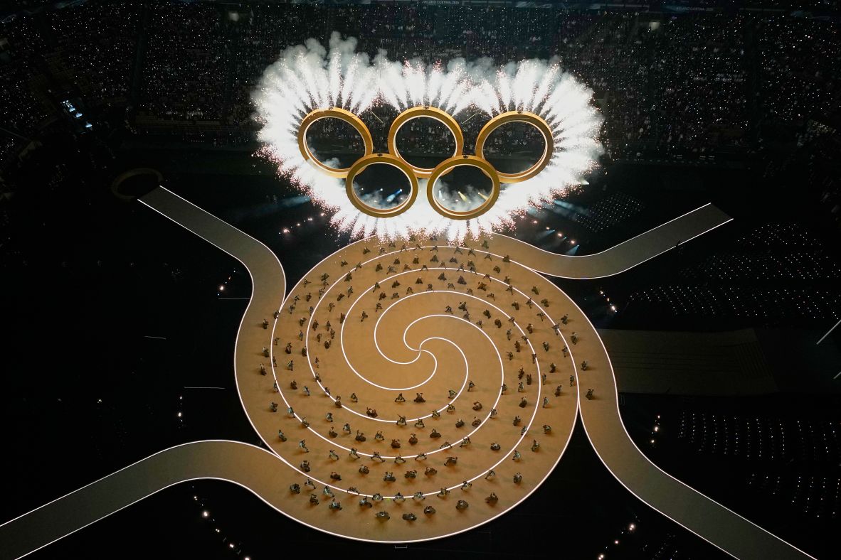 Fireworks shoot out from the Olympic rings after the rings formed dramatically above the stage in Milan.