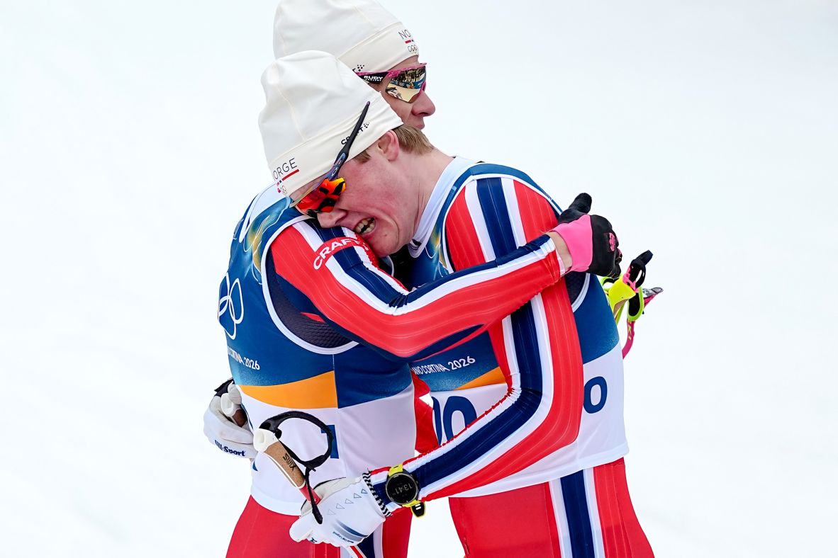 Gold medalist Johannes Høsflot Klæbo of Norway, left, hugs bronze medalist Opstad Oskar Vike, also of Norway, after the <a href=