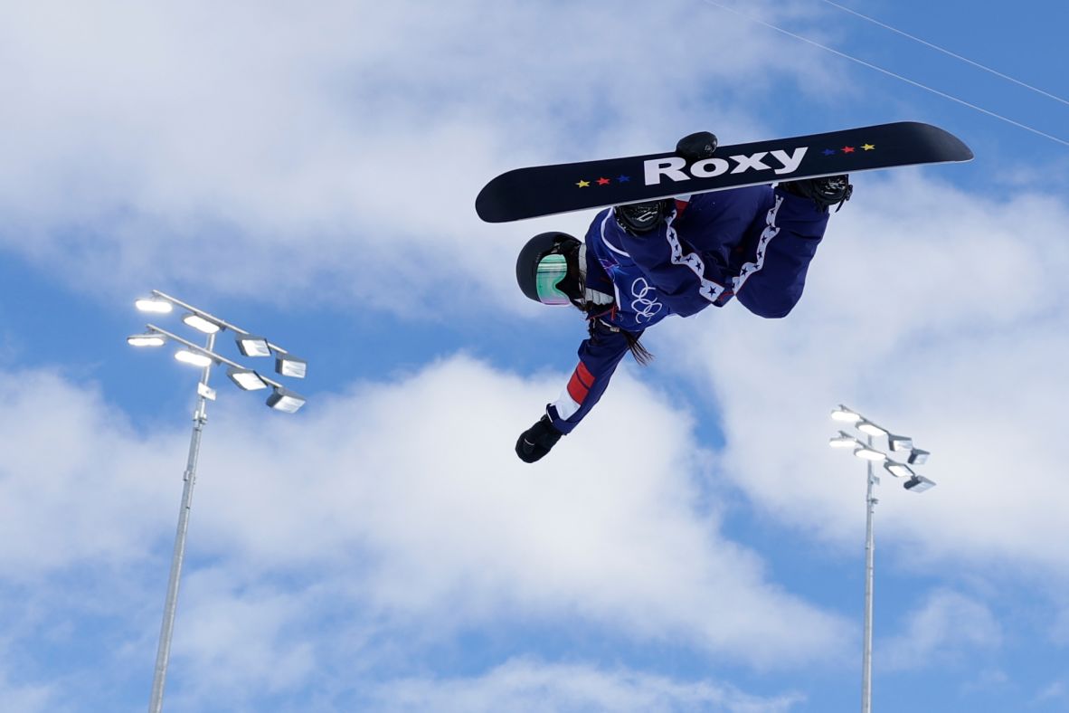 American snowboarder Chloe Kim grabs her board as she <a href=