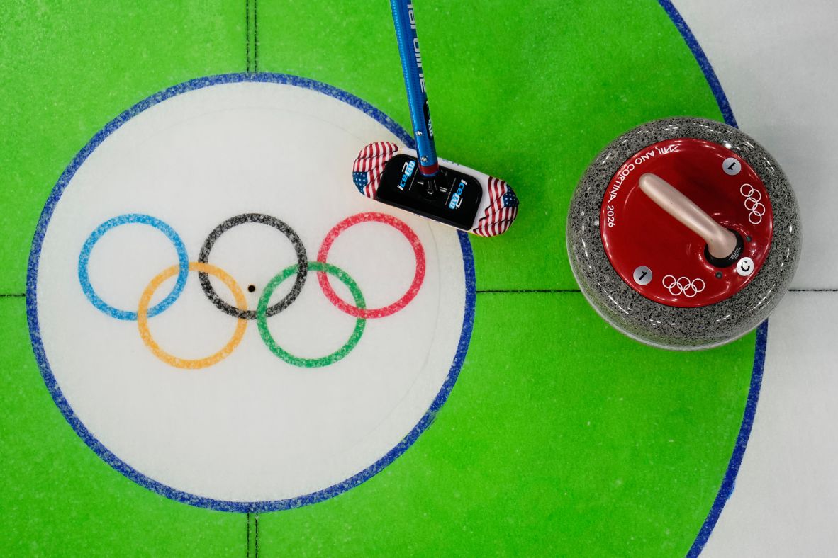 Taylor Anderson-Heide of the United States sweeps near a stone during a women's curling round-robin game against Denmark on February 17.