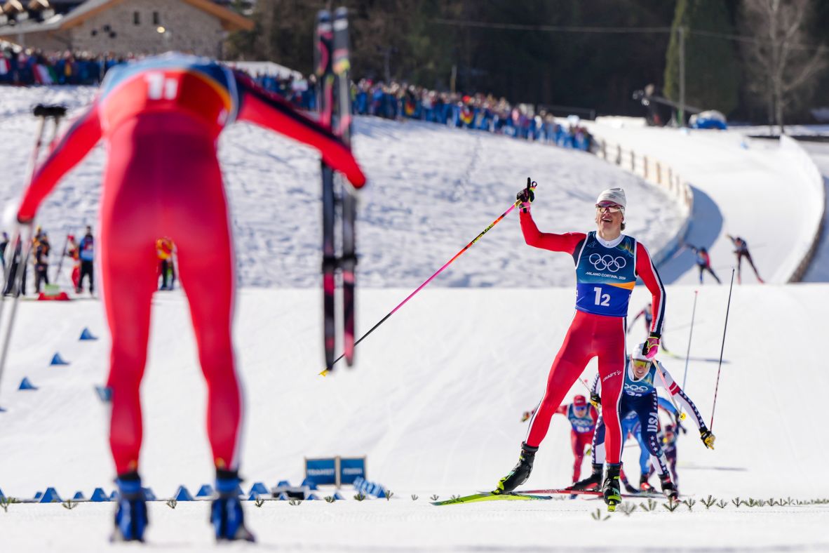 Norway's Einar Hedegart bows to teammate Johannes Høsflot Klæbo as he approaches the finish line to <a href=