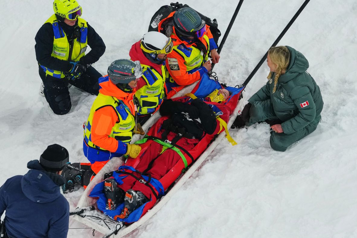 Medical staff load Canada's Cassie Sharpe onto a stretcher after she crashed during the freestyle skiing halfpipe qualifications on February 19.
