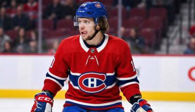 Artemi Panarin depicted wearing a red Montreal Canadiens home uniform and blue helmet, standing on the ice with his tongue sticking out during a game.