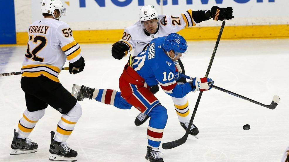 New York Rangers forward Artemi Panarin (10) skates between Boston Bruins center Sean Kuraly (52) and defenseman Henri Jokiharju (20) during the third period of an NHL hockey game Monday, Jan. 26, 2026, in New York. (AP Photo/John Munson)