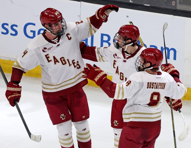 Andre Gasseau, James Hagens and Lukas Gustafsson of the Boston College Eagles celebrate their fourth goal against Harvard during the second period of the men's Beanpot semifinals at TD Garden.  (Photo By Matt Stone/Boston Herald)