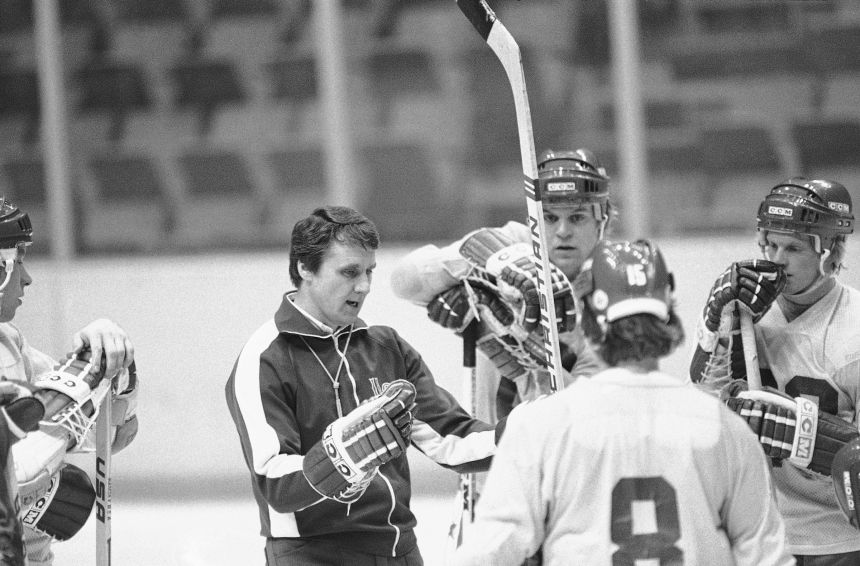Members of the US Olympic ice hockey team get advice from coach Herb Brooks, left, during a break of their workout session in Lake Placid, New York, on February 7, 1980.