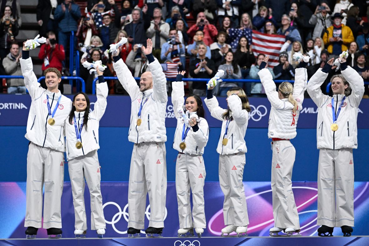 Members of Team USA's figure skating team celebrate on the podium after <a href=
