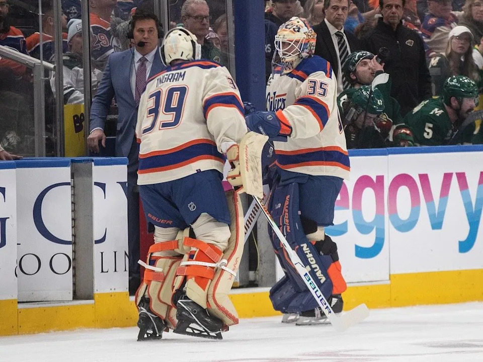  Edmonton Oilers goalies Connor Ingram (39) and Tristan Jarry (35) bump gloves after Jarry was pulled from the game against the Minnesota Wild during the second period on Saturday, Jan. 31, 2026. Jason Franson/Canadian Press