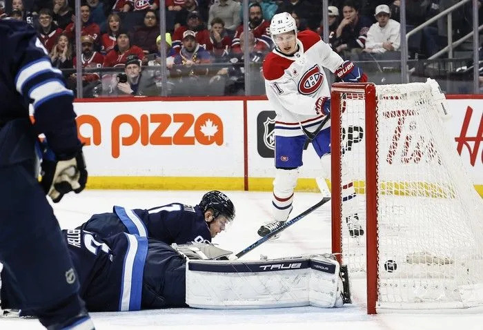  Montreal Canadiens’ Oliver Kapanen scores on Winnipeg Jets goaltender Connor Hellebuyck (#37) during the first period at Canada Life Centre on February 4, 2026.