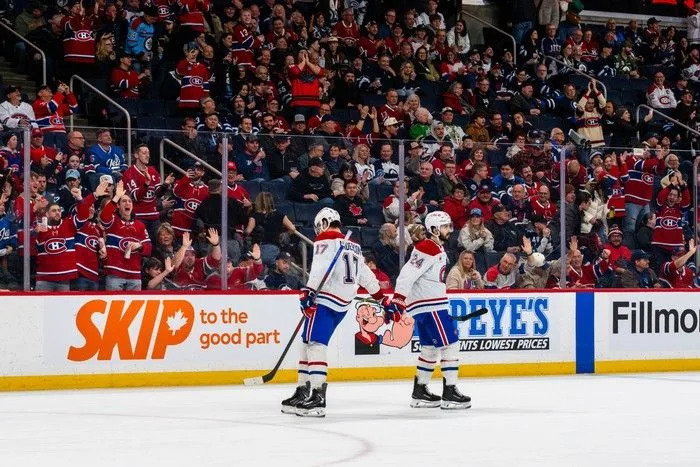  Phillip Danault (#24) of the Montreal Canadiens celebrates his empty-net goal with Josh Anderson (#17) in the third period against the Winnipeg Jets at Canada Life Centre on February 4, 2026.