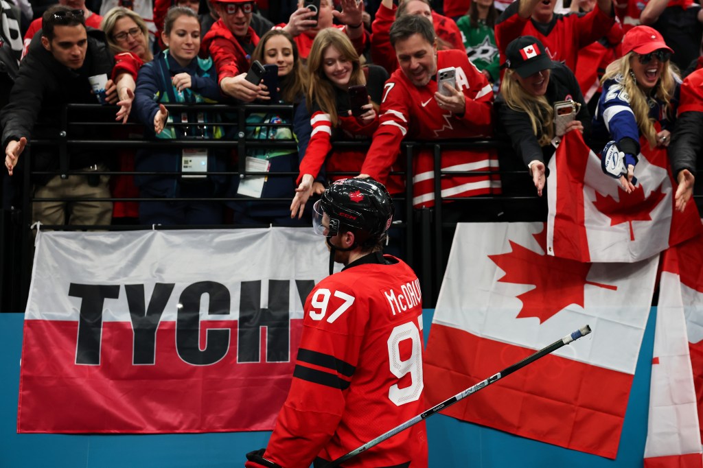 Connor McDavid #97 of Team Canada acknowledges fans after their 3-2 victory against Finland at the Milano Cortina 2026 Winter Olympics.