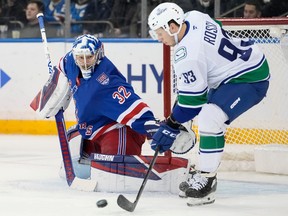 Vancouver Canucks center Marco Rossi (93) attempts to shoot the puck past New York Rangers goaltender Jonathan Quick (32) on Dec. 16, 2025, in New York. Rossi returns to the Canucks' lineup against the Winnipeg Jets on Wednesday night at Rogers Arena.