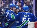 Vancouver Canucks' Drew O'Connor (18), Jake DeBrusk (74) and Aatu Raty (54) celebrate O'Connor's goal against the Anaheim Ducks during the third period at Rogers Arena on Thursday night. The Canucks won 2-0.