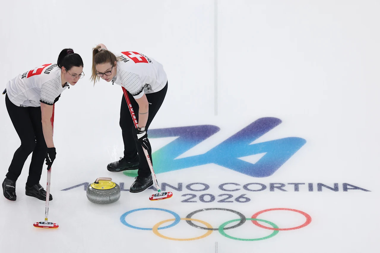 CORTINA D'AMPEZZO, ITALY - FEBRUARY 20: Alina Paetz and Carole Howald of Team Switzerland compete during the Women's semi-final match between Team United States and Team Switzerland on day fourteen of the Milano Cortina 2026 Winter Olympic games at Cortina Curling Olympic Stadium on February 20, 2026 in Cortina d'Ampezzo, Italy. (Photo by Richard Heathcote/Getty Images)