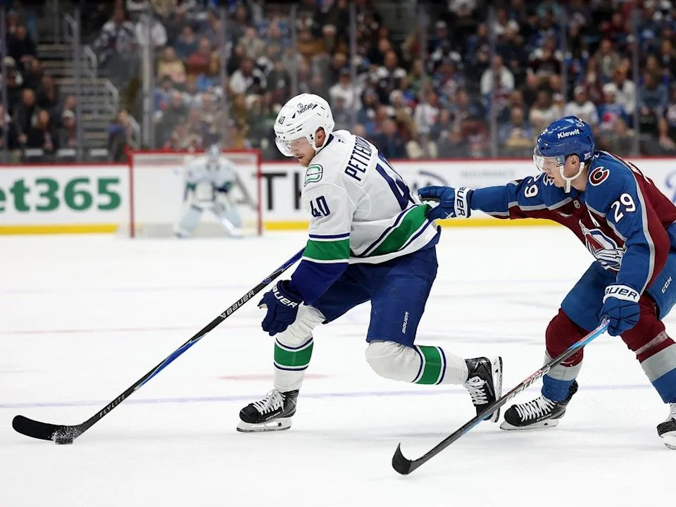  Canucks centre Elias Pettersson makes a move on Nathan MacKinnon of the Avalanche during Dec. 2 game at Ball Arena in Denver. Avs won 3-1.