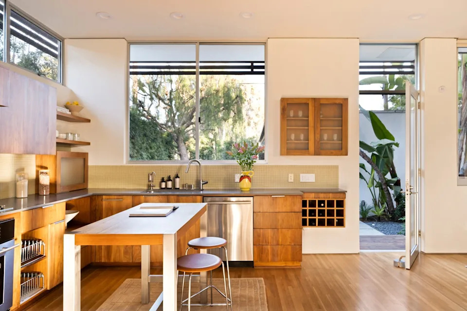 The sleek gourmet kitchen opens up to the outdoor living area. <span class="image-credit">(Engles Studios)</span>