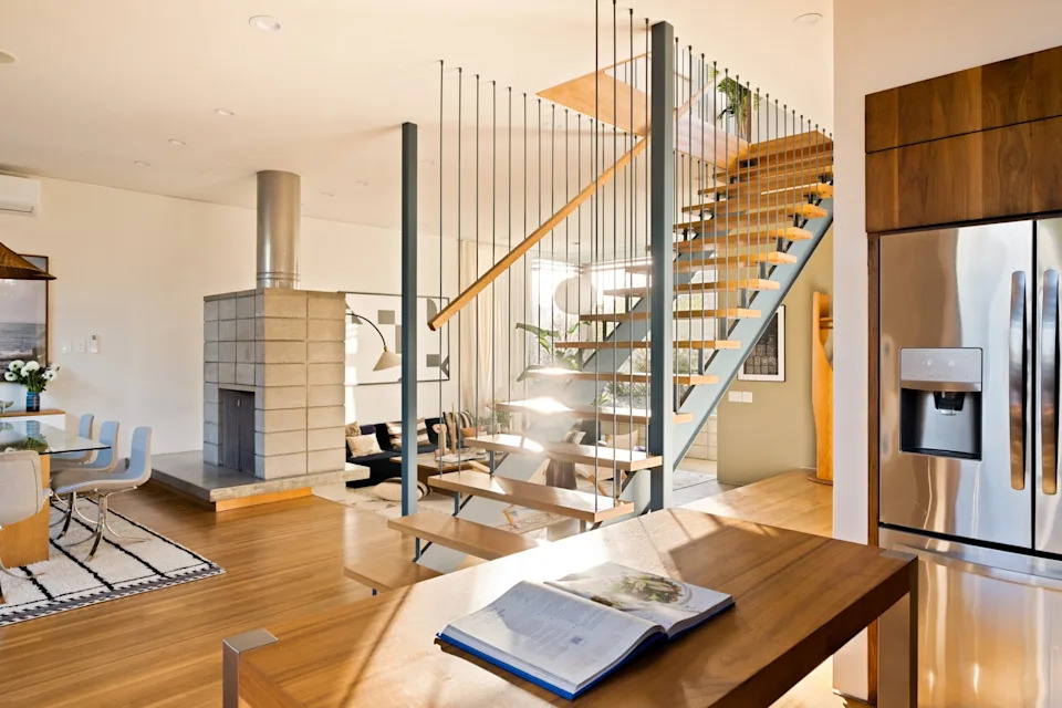 A sculptural floating staircase leads up to the three bedrooms. <span class="image-credit">(Engles Studios)</span>