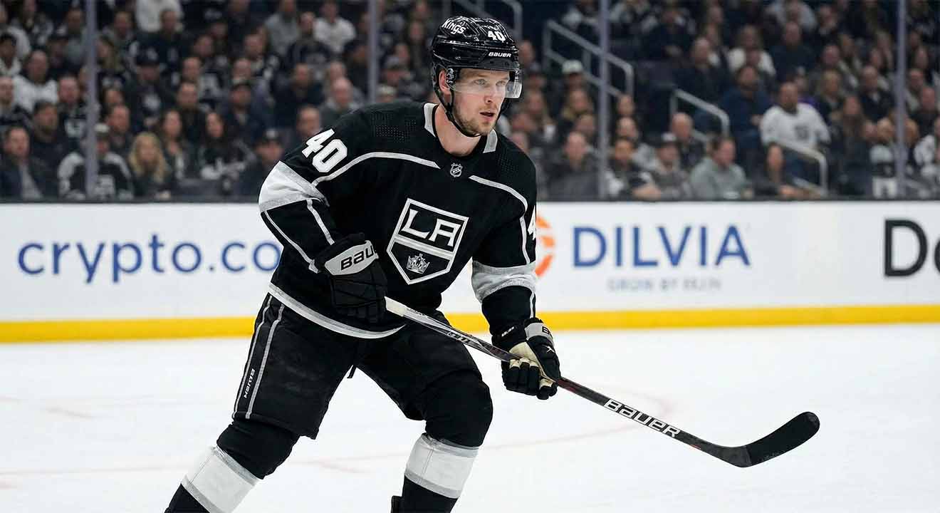 Elias Pettersson, wearing a black Los Angeles Kings #40 jersey and helmet, stands on the ice holding his hockey stick during a game.