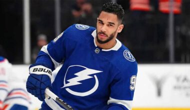 Evander Kane wearing a blue Tampa Bay Lightning home uniform, number 9, skating on the ice and holding his hockey stick during a game.