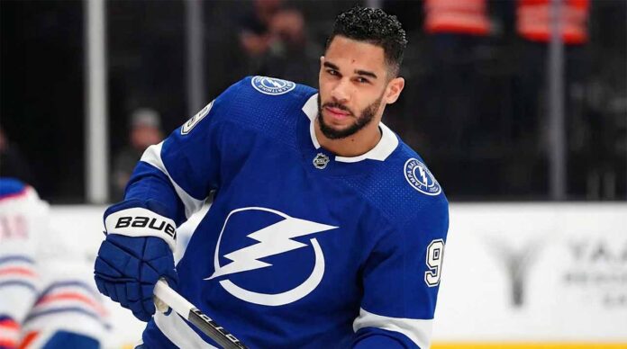 Evander Kane wearing a blue Tampa Bay Lightning home uniform, number 9, skating on the ice and holding his hockey stick during a game.