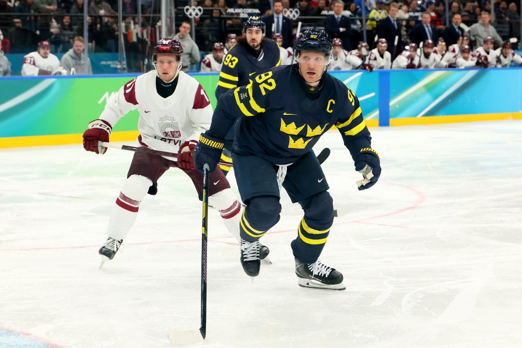 Gabriel Landeskog #92 of Team Sweden skates with the puck during a Men's Qualification Playoff match against Latvia at the Milano Cortina 2026 Winter Olympic games.