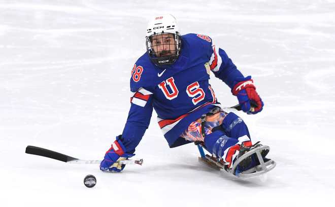 BOSTON, MASSACHUSETTS - FEBRUARY 19: Kevin McKee #88 of Team USA controls the puck during the first period of the Reeve Hockey Classic sled hockey game between Team USA and Team Canada at Kasabuski Rink on February 19, 2025 in Boston, Massachusetts.  (Photo by Steve Babineau/NHLI via Getty Images)