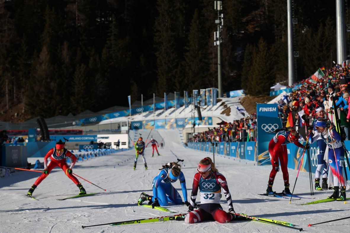 Austria's Anna Gandler, front, rests after crossing the finish line during the women's biathlon 10km pursuit  on February 15.