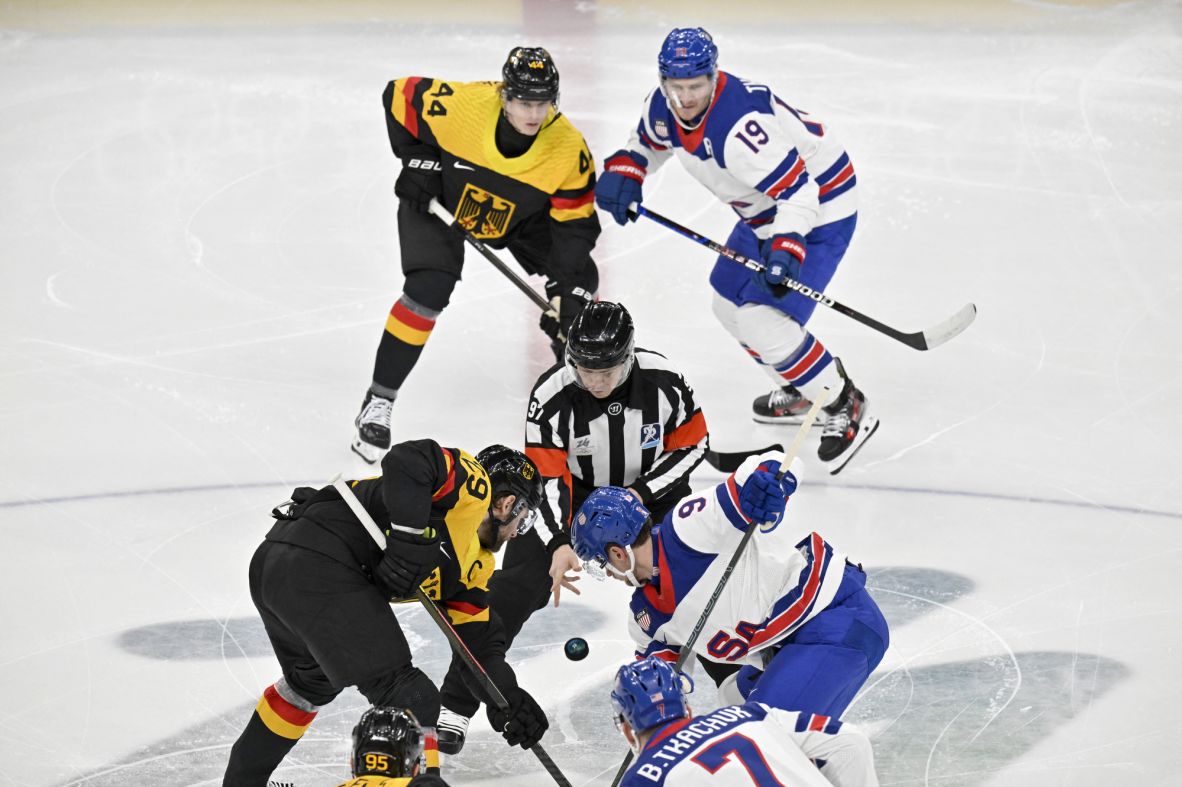 Referee Jan Hribik drops the puck for the start of a hockey game between USA and Germany on February 15.