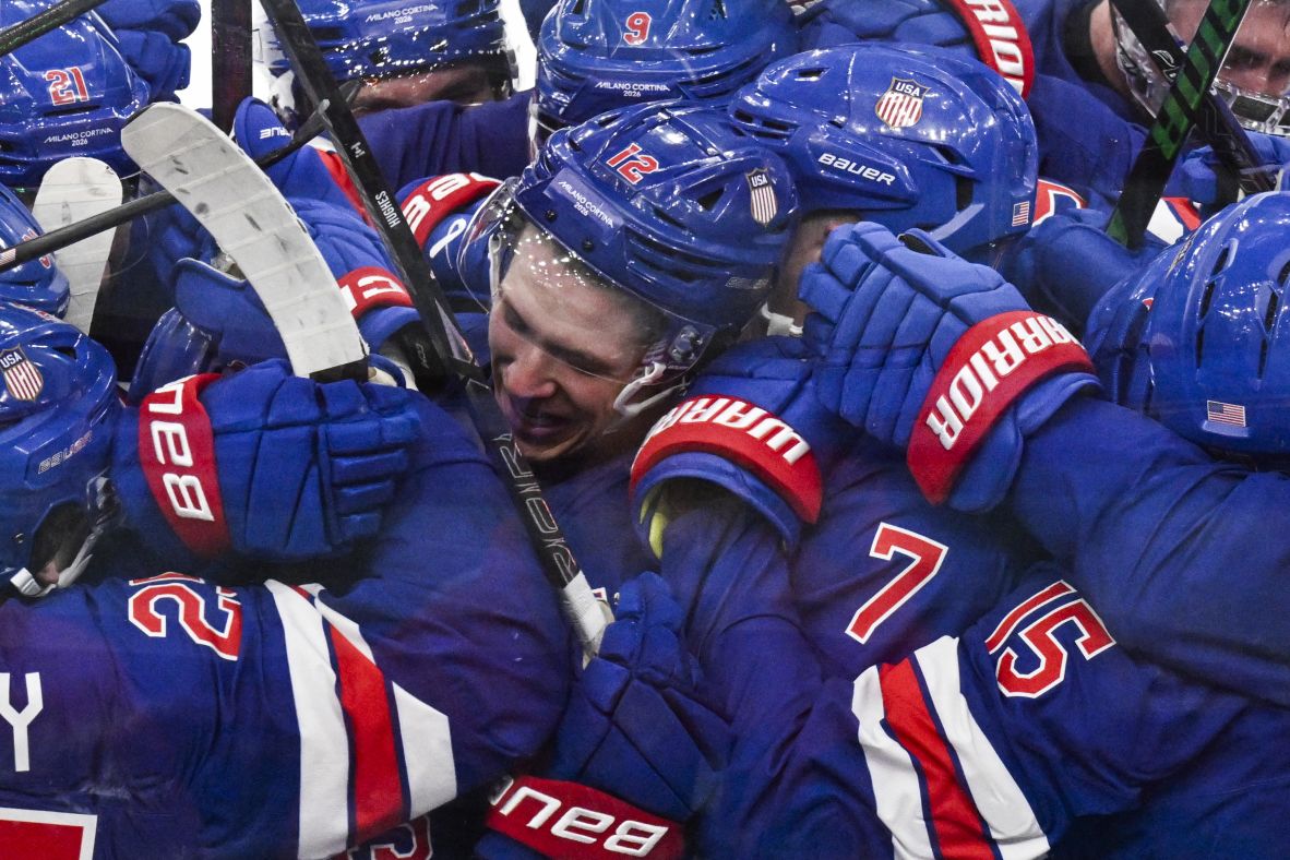 Team USA's Quinn Hughes celebrates with teammates after he scored <a href=