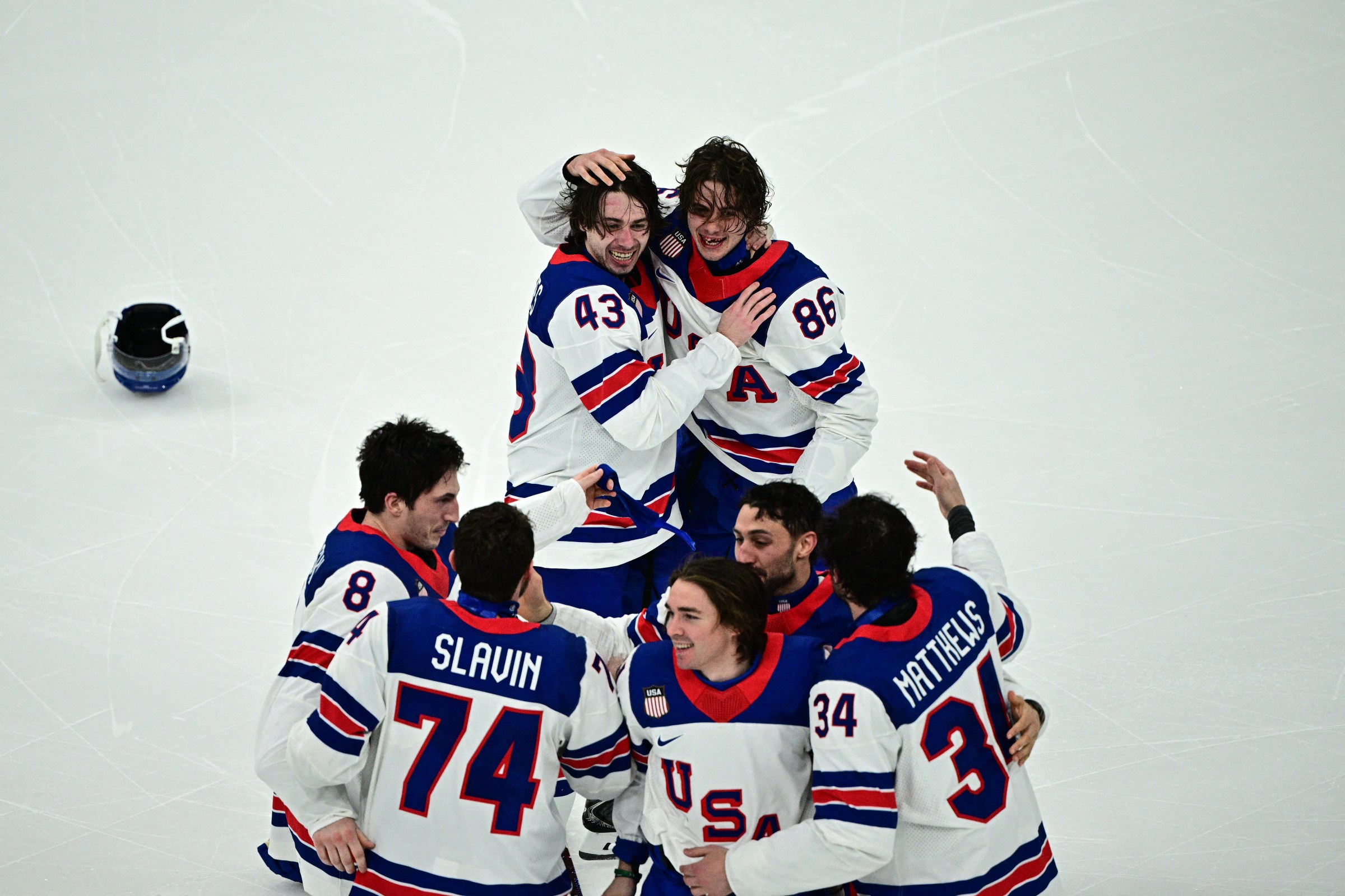 USA’s players celebrate after winning the men’s gold medal ice hockey match between Canada and USA at the Milano Santagiulia Ice Hockey Arena during the Milano Cortina 2026 Winter Olympic Games in Milan, on February 22, 2026. (Photo by JULIEN DE ROSA / AFP via Getty Images)