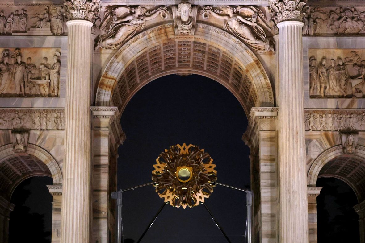 The Olympic flame is extinguished from the cauldron at the Arco della Pace in Milan.