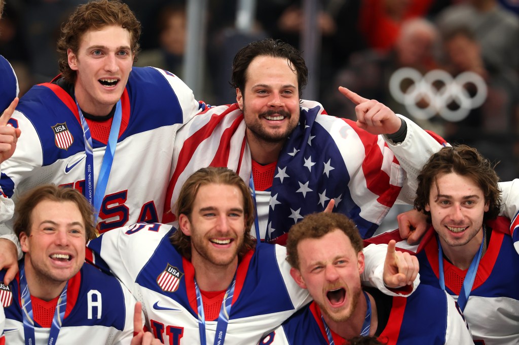 USA captain Auston Matthews (34) and teammates pose for a photo after winning the Olympic gold medal on Feb. 22, 2026.